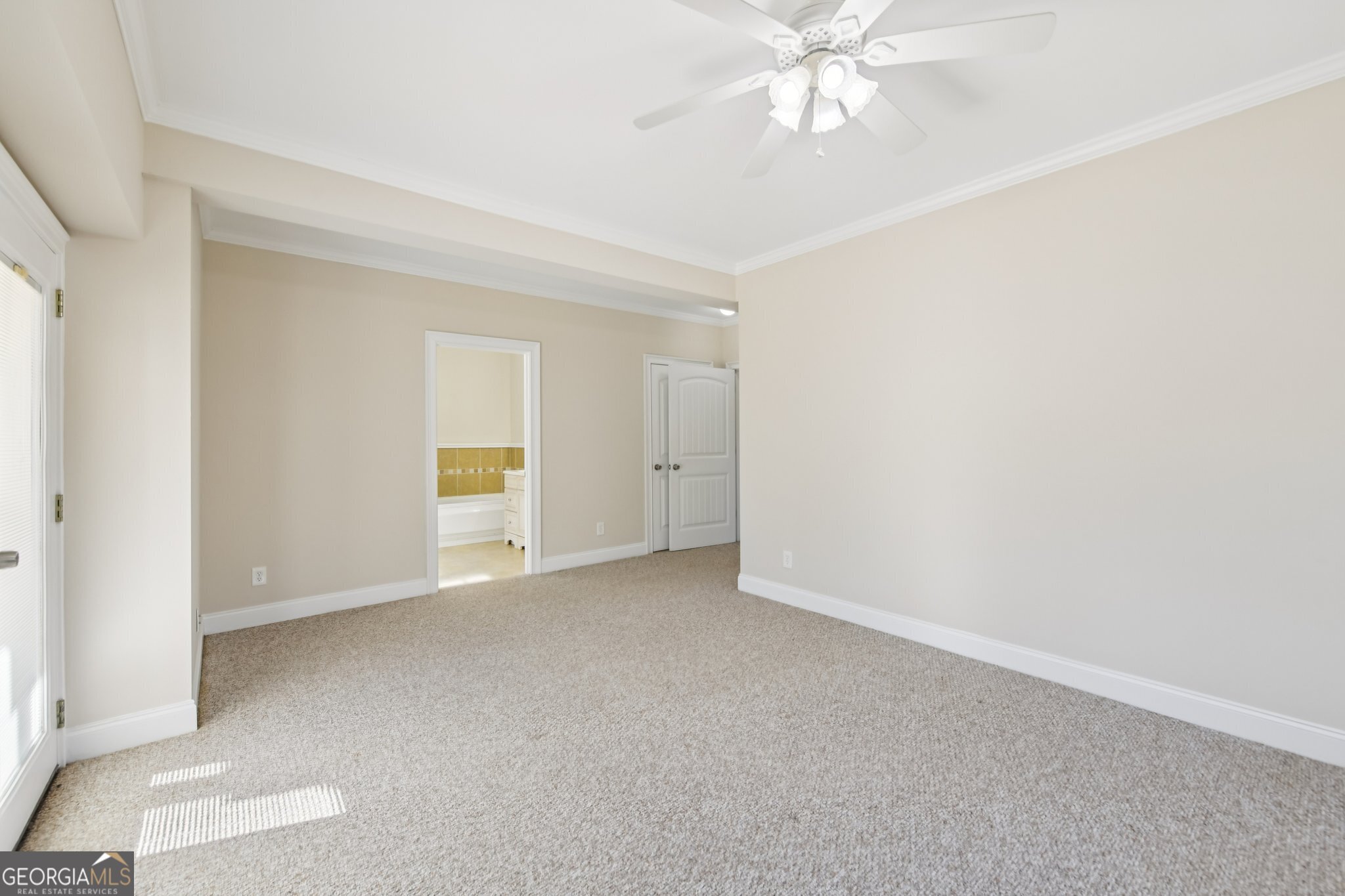 590 Ridge Road Dawsonville, GA 30534 - Photo 44 of 79 an empty room with chandelier fan and windows
