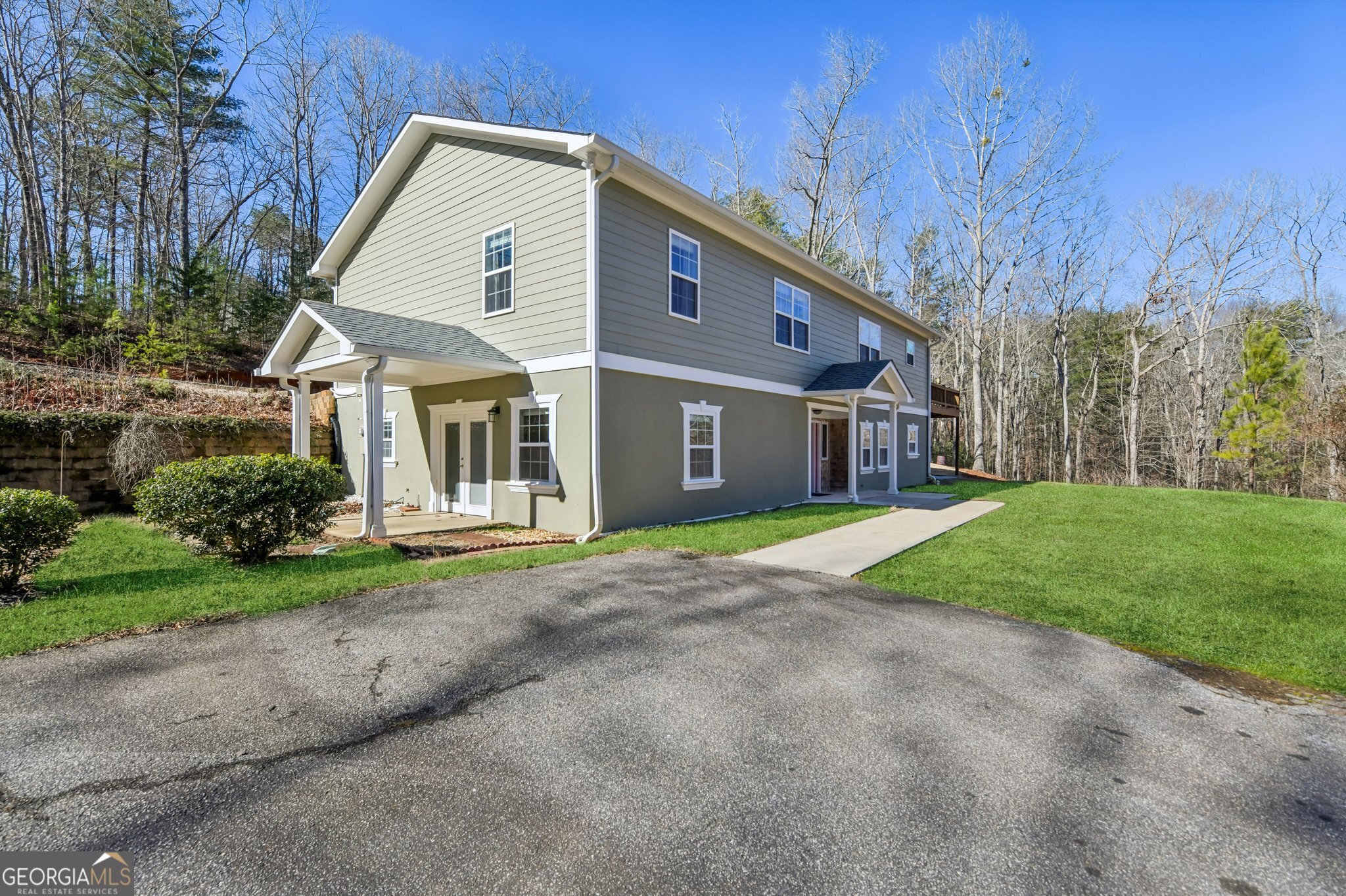 590 Ridge Road Dawsonville, GA 30534 - Photo 5 of 79 a front view of a house with a yard and garage