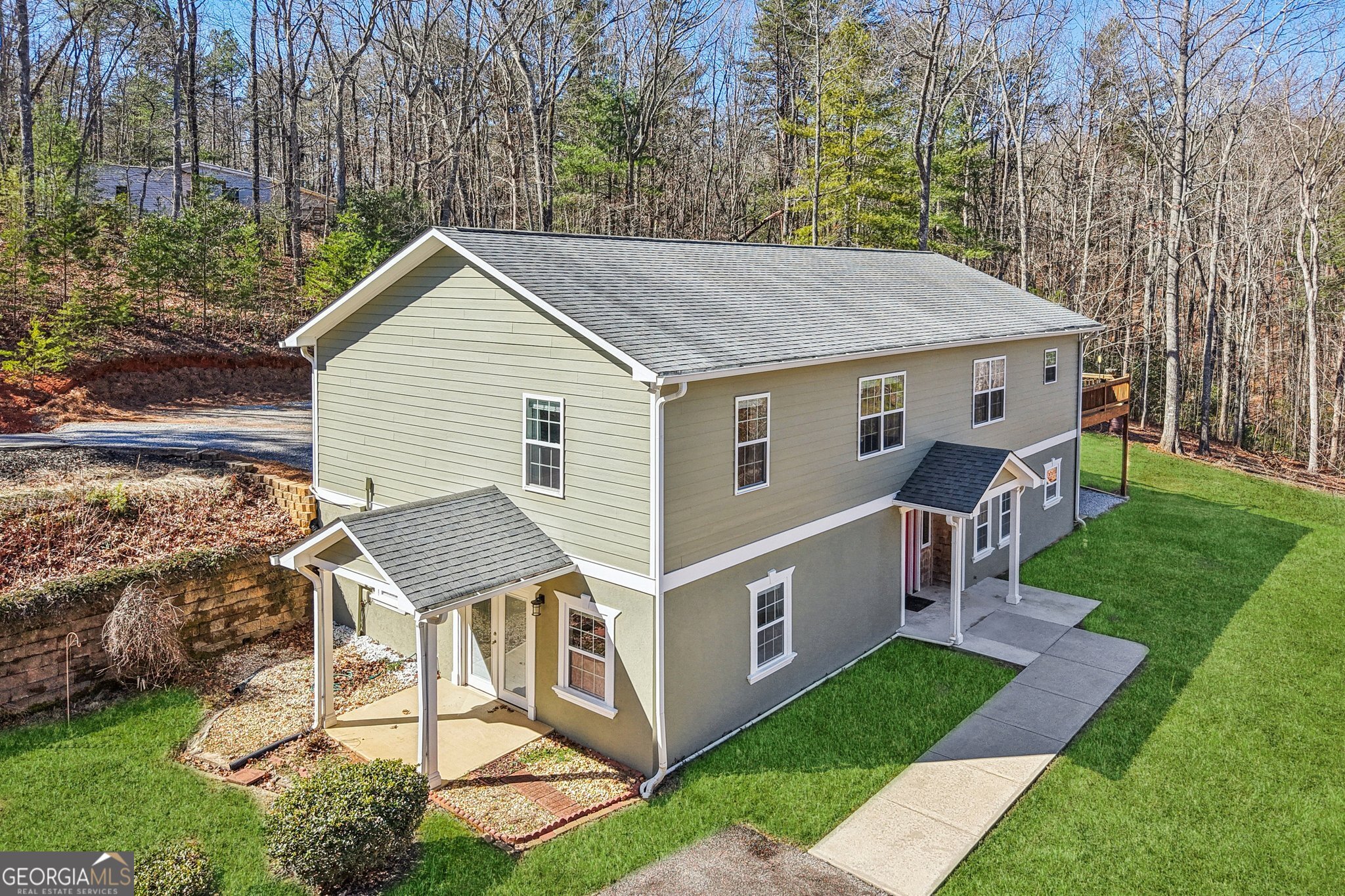 590 Ridge Road Dawsonville, GA 30534 - Photo 61 of 79 a aerial view of a house with yard and trees in the background