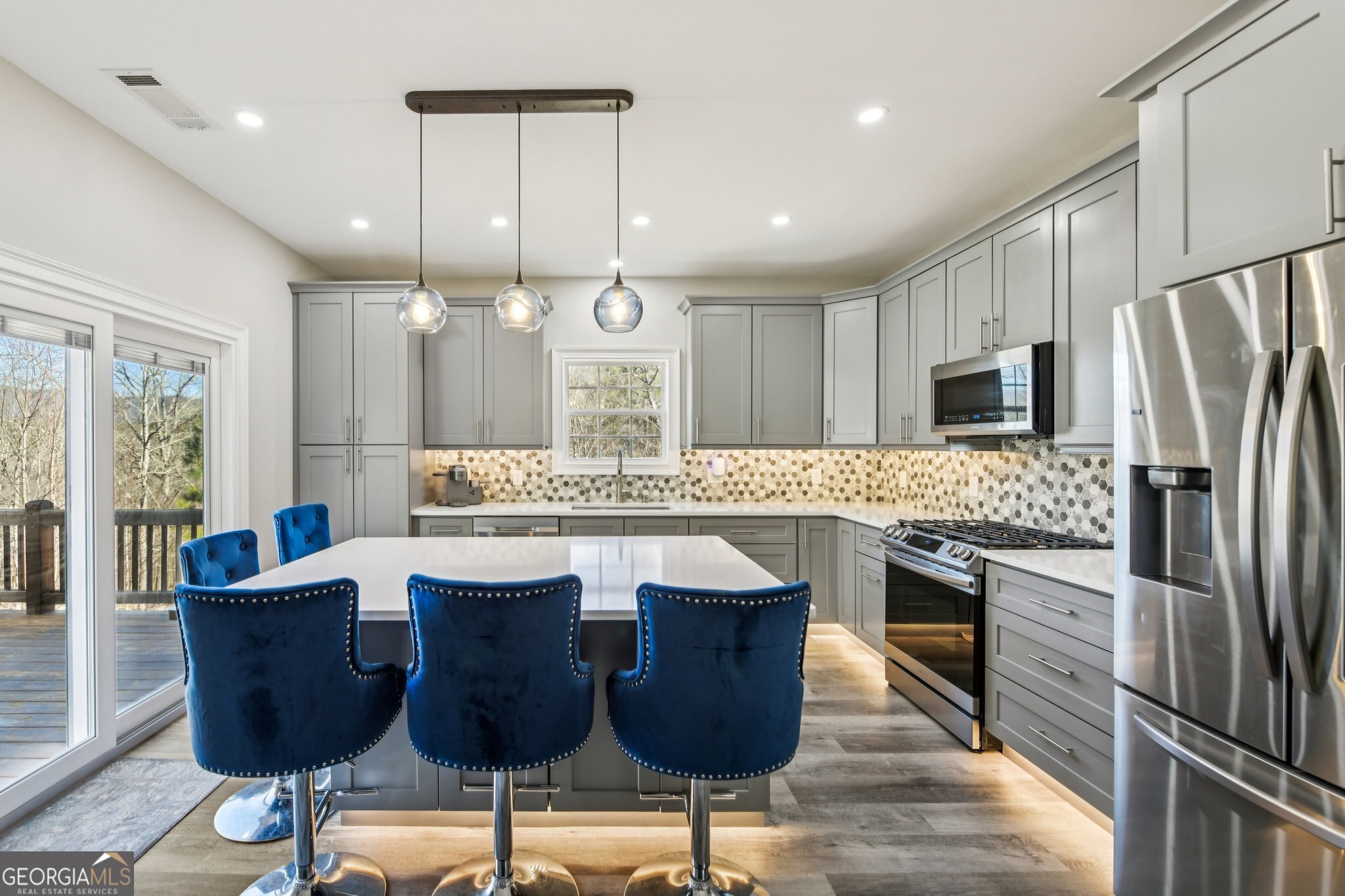 590 Ridge Road Dawsonville, GA 30534 - Photo 9 of 79 a kitchen with stainless steel appliances granite countertop a kitchen island a stove a cabinets a sink and a refrigerator