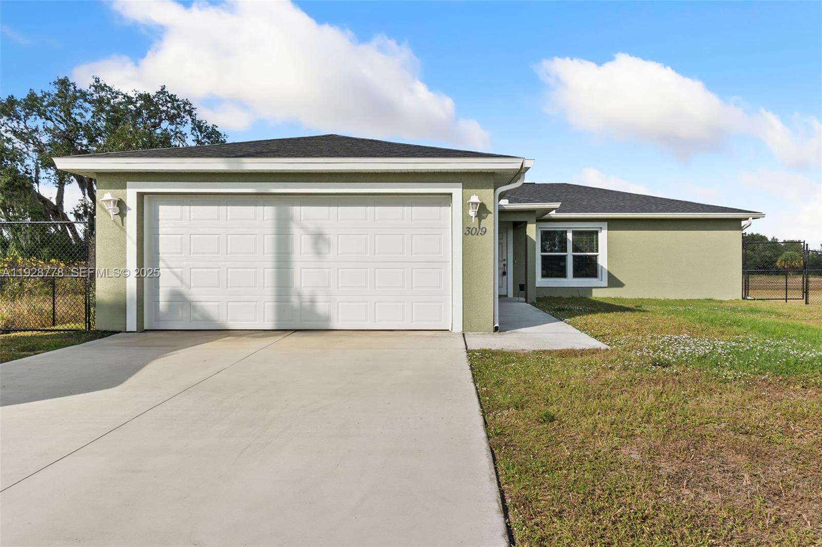 3019 Honeywood Road LaBelle, FL 33935 - Photo 1 of 18 front view of the house with a yard