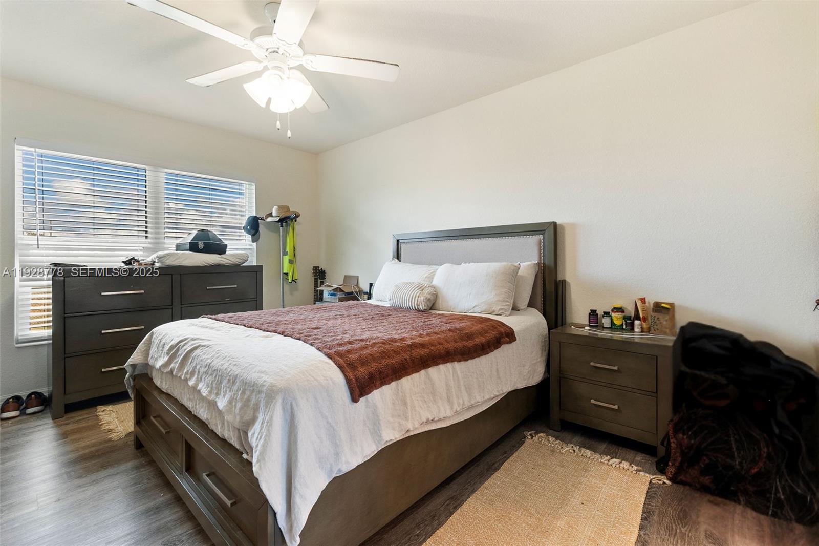 3019 Honeywood Road LaBelle, FL 33935 - Photo 11 of 18 a bedroom with a bed and a chandelier