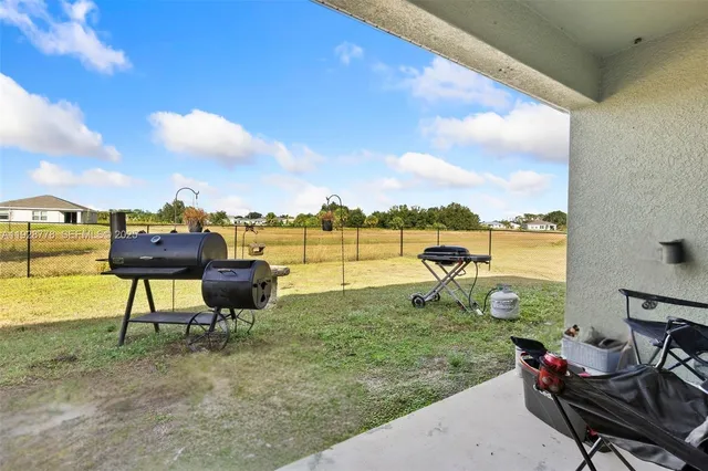 a view of a lake with table and chairs