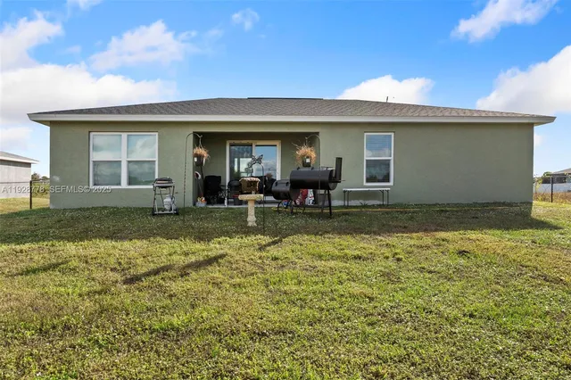 a view of a house with backyard porch and furniture