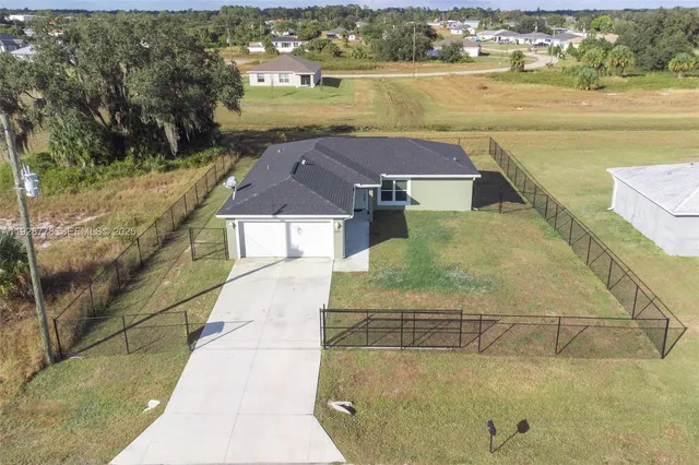an aerial view of residential houses with outdoor space and swimming pool