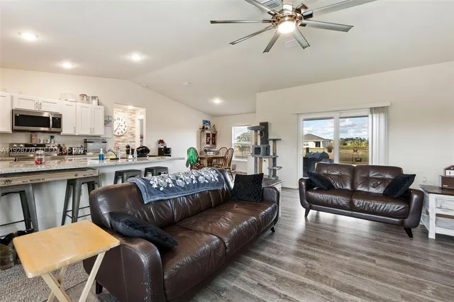 a view of a living room kitchen and a wooden floor