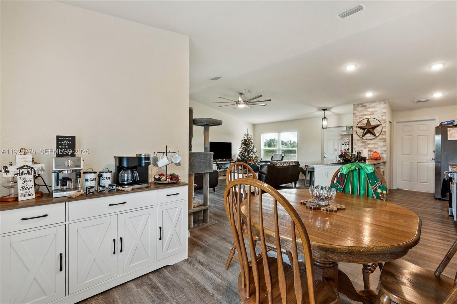 3019 Honeywood Road LaBelle, FL 33935 - Photo 9 of 18 a kitchen with stainless steel appliances kitchen island granite countertop a table chairs and a refrigerator