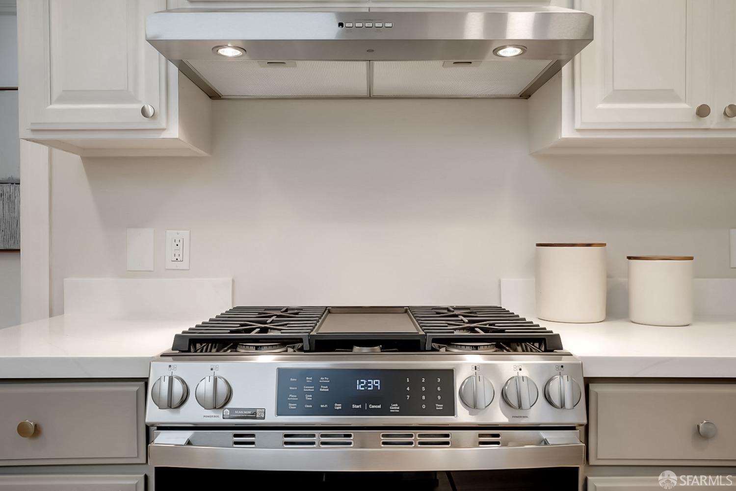 1674 25th Avenue San Francisco, CA 94122 - Photo 11 of 42 a stove top oven sitting inside of a kitchen