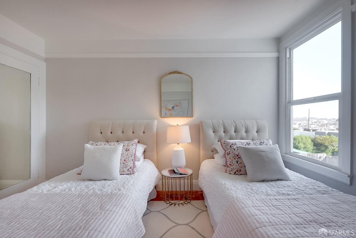 1674 25th Avenue San Francisco, CA 94122 - Photo 15 of 42 a bedroom with a bed and a window