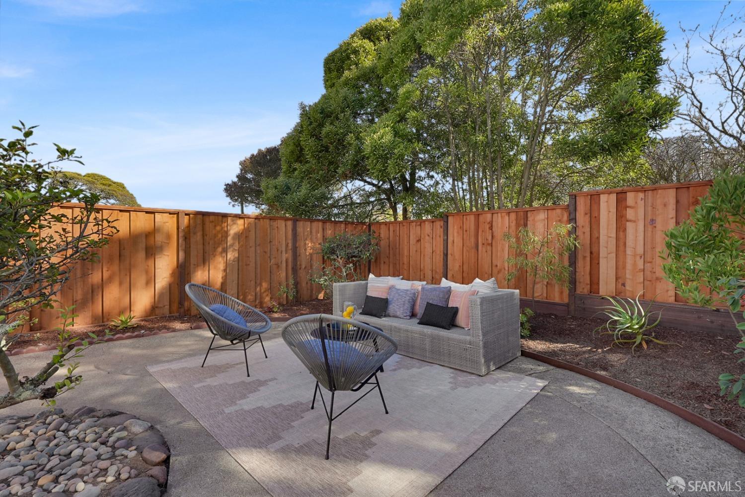 1674 25th Avenue San Francisco, CA 94122 - Photo 34 of 42 a backyard of a house with table and chairs