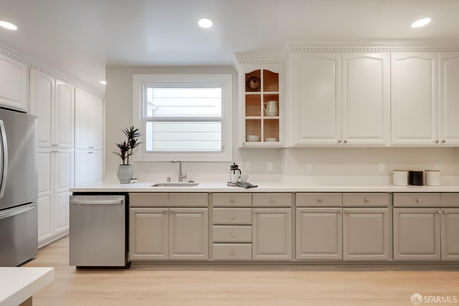 1674 25th Avenue San Francisco, CA 94122 - Photo 9 of 42 a kitchen with a sink cabinets and stainless steel appliances