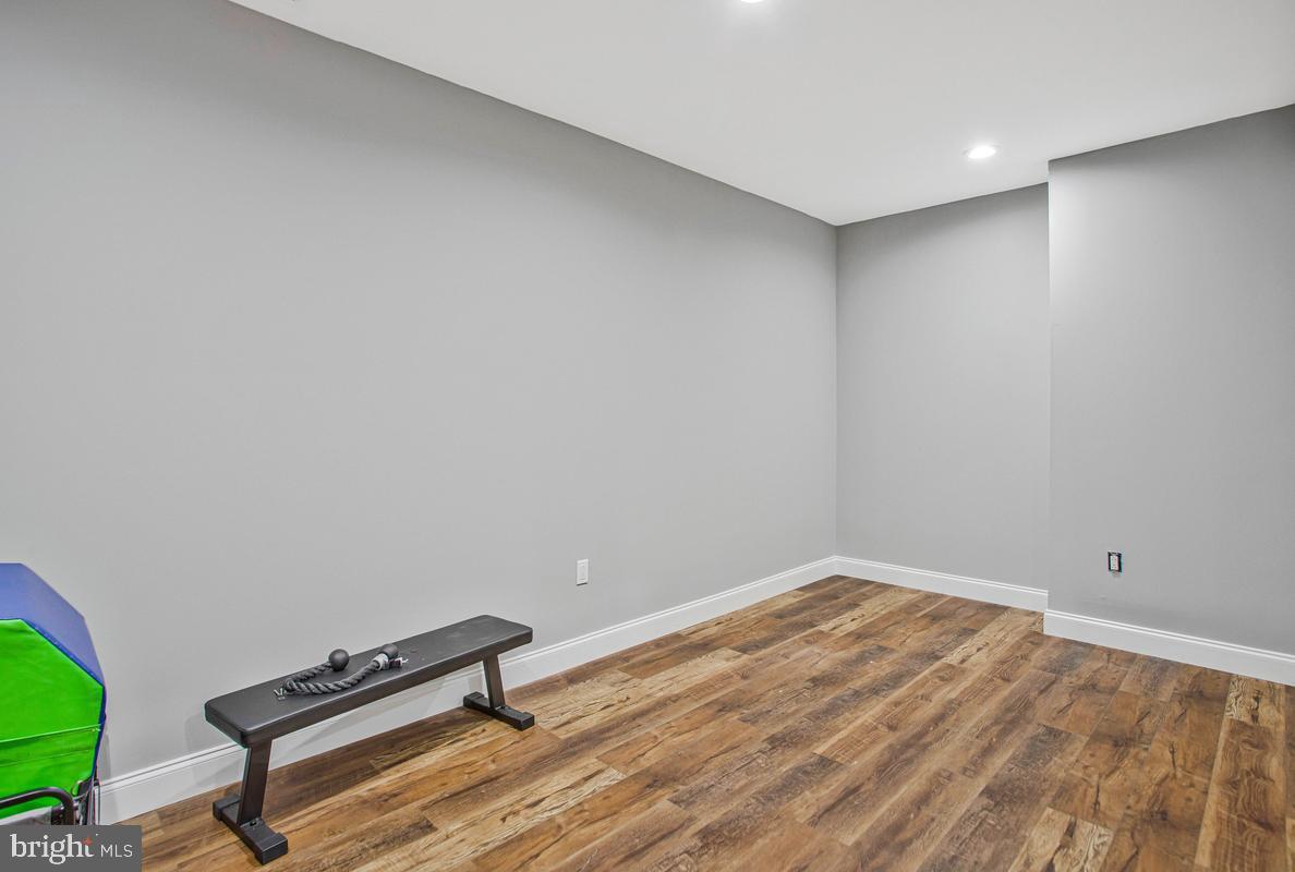 5 Jessie Road Harwood, MD 20776 - Photo 65 of 87 a room with a bench and a wooden floor