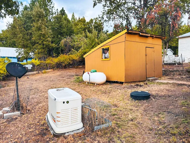 a backyard of a house with table and chairs
