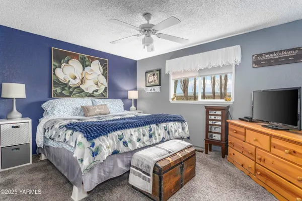 a bedroom with a bed and a flat screen television