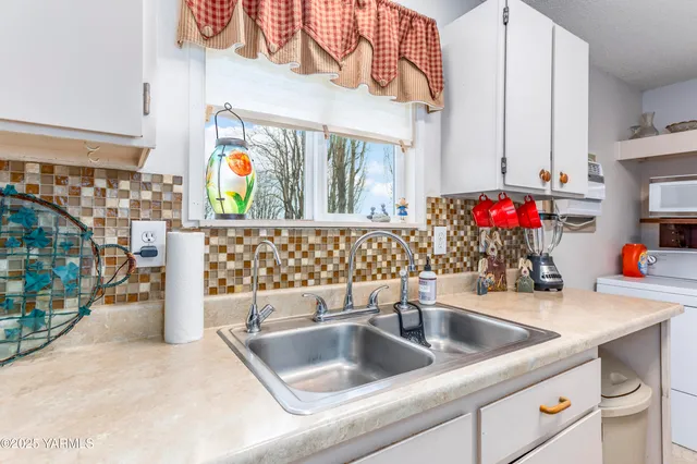 a kitchen with a sink and a refrigerator