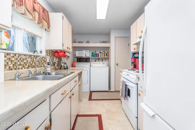 a kitchen with a sink stove and refrigerator