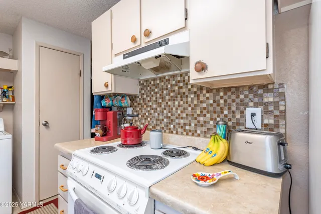 a bathroom with a sink a stove and a refrigerator