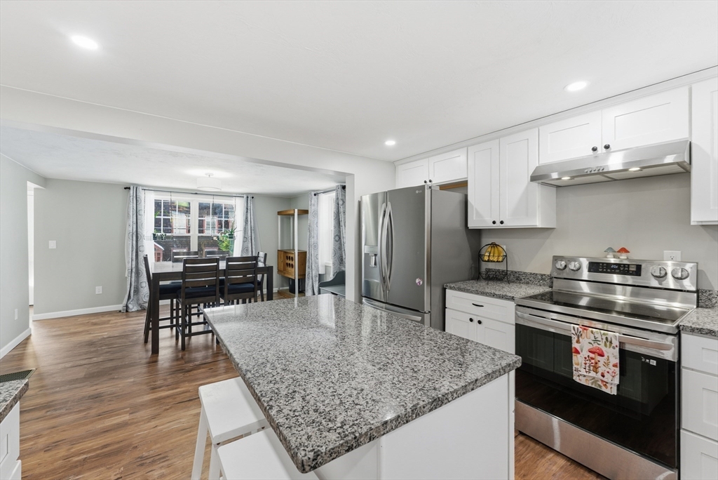160 Cottage Street Athol, MA 01331 - Photo 8 of 35 a kitchen with stainless steel appliances granite countertop a stove top oven a sink dishwasher and cabinets with wooden floor
