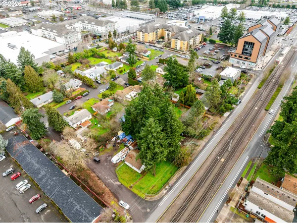 an aerial view of a house with a yard and outdoor seating