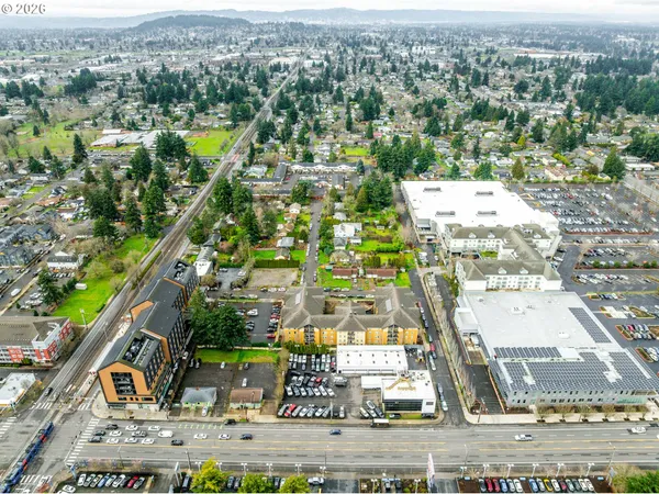 an aerial view of residential houses with outdoor space and street view