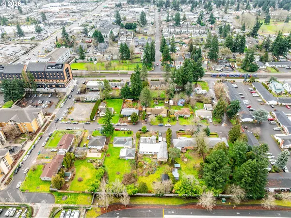 an aerial view of residential houses with outdoor space and parking