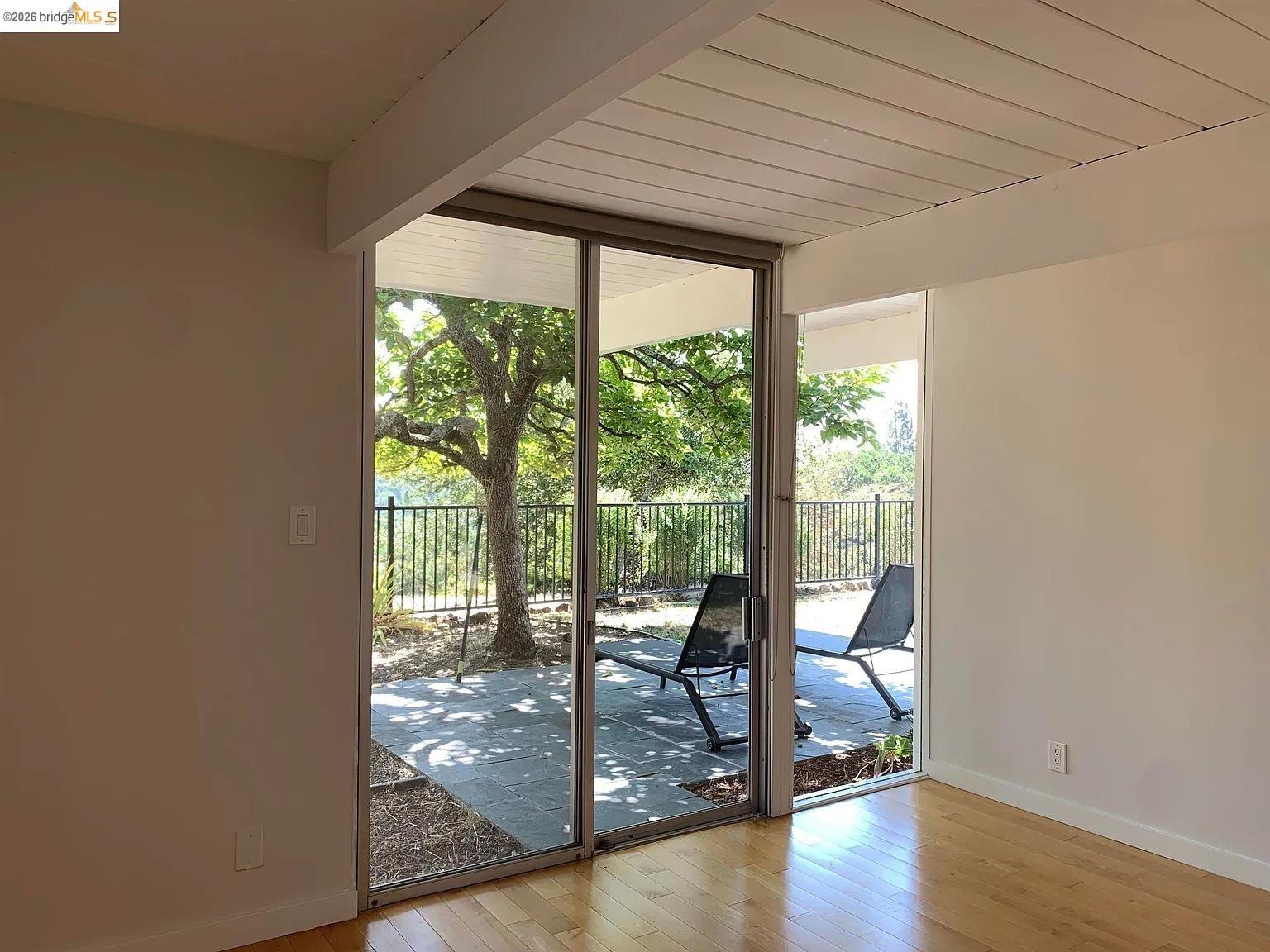 5559 Greenridge Road Castro Valley, CA 94552 - Photo 15 of 33 Doorway featuring wood-type flooring and floor to ceiling windows