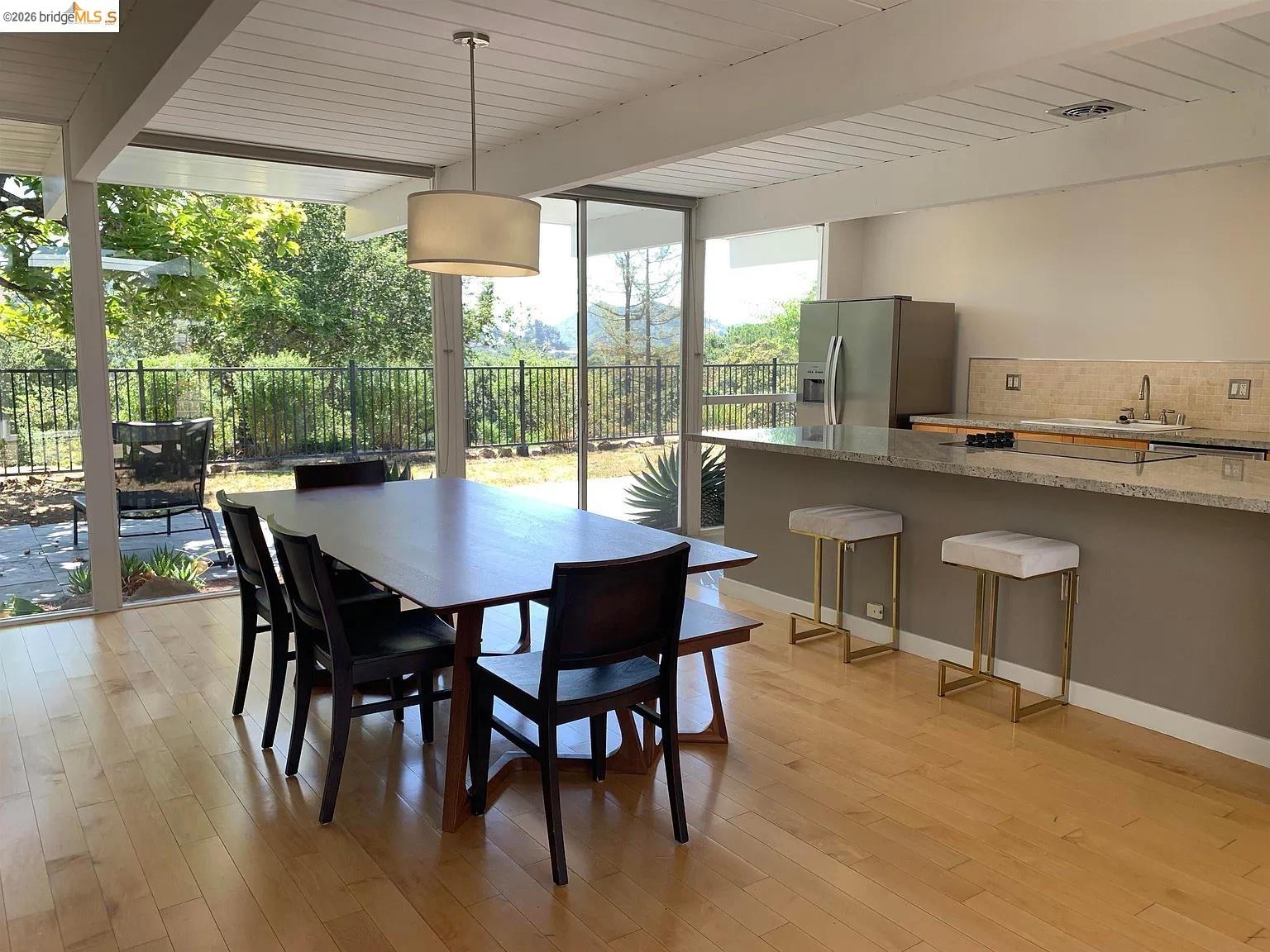 5559 Greenridge Road Castro Valley, CA 94552 - Photo 18 of 33 Dining area with floor to ceiling windows, beamed ceiling, and light wood-style flooring