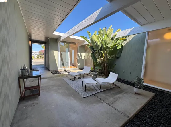 a dining room with furniture and wooden floor