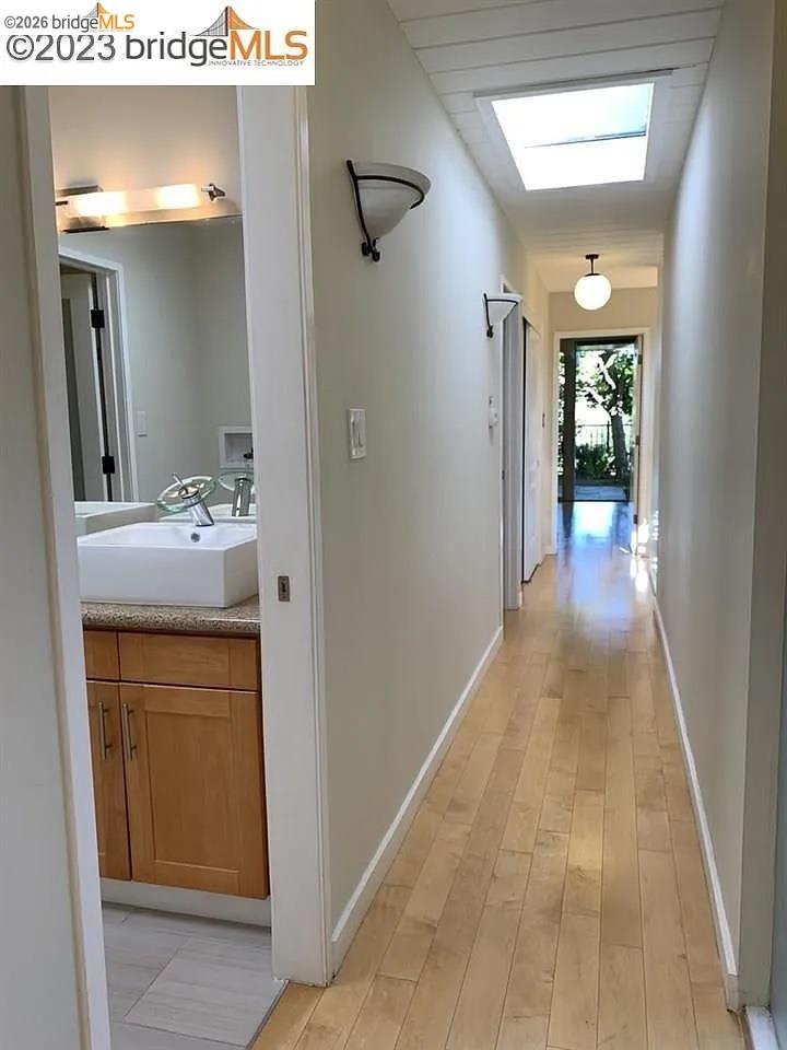 5559 Greenridge Road Castro Valley, CA 94552 - Photo 9 of 33 Corridor with light wood-type flooring and a skylight
