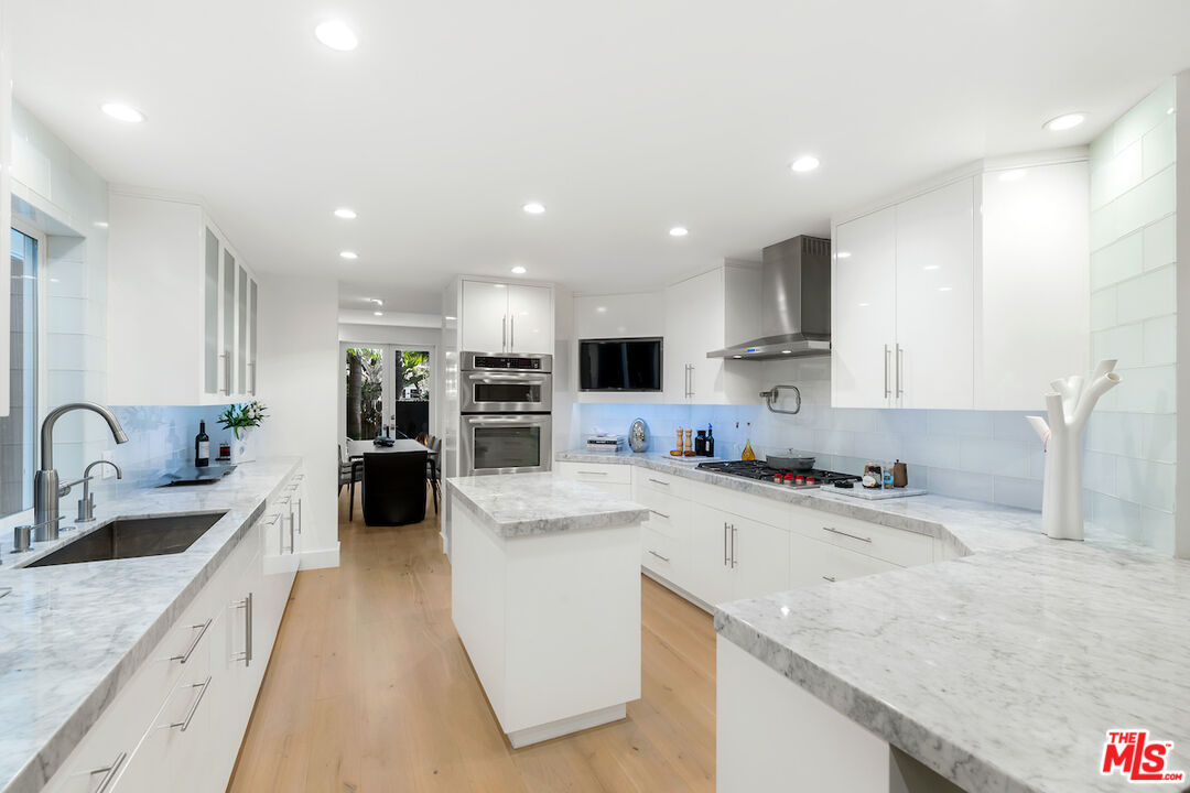 135 Mast Mall Marina del Rey, CA 90292 - Photo 12 of 32 a large kitchen with stainless steel appliances a sink a stove and a refrigerator