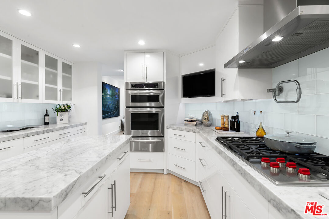 135 Mast Mall Marina del Rey, CA 90292 - Photo 13 of 32 a kitchen with stainless steel appliances a stove a sink and a microwave