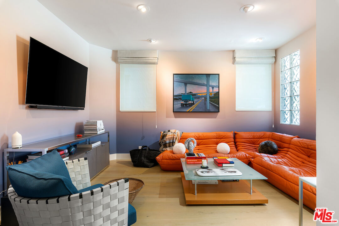 135 Mast Mall Marina del Rey, CA 90292 - Photo 14 of 32 a blue room with furniture and a flat screen tv