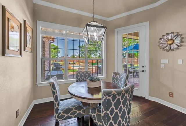 a dining room with furniture a chandelier and wooden floor