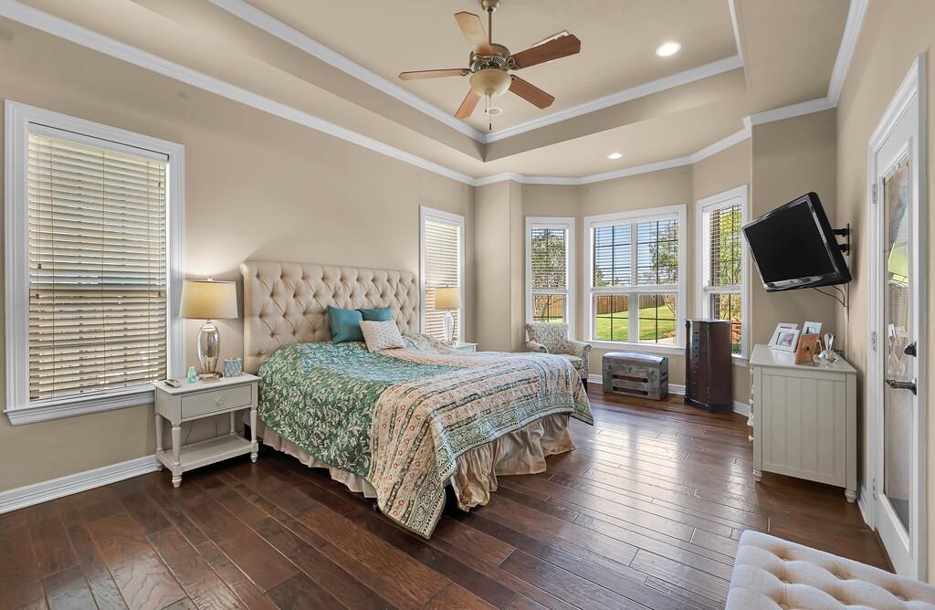 74 Independence Trail Waco, TX 76708 - Photo 18 of 40 a bedroom with a bed a flat screen tv and a couch