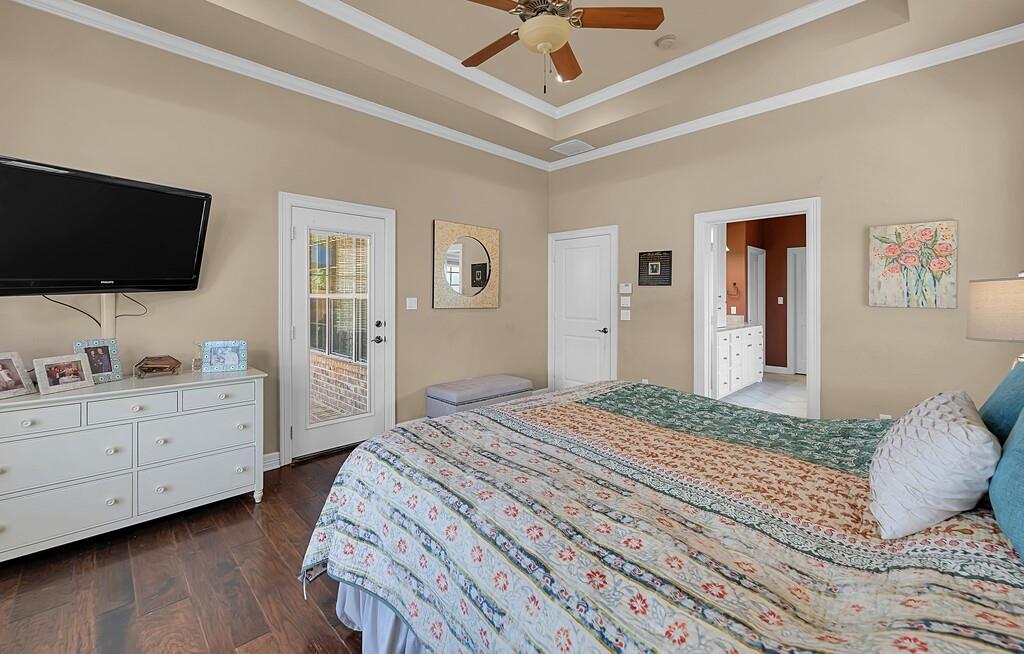 74 Independence Trail Waco, TX 76708 - Photo 19 of 40 a bedroom with a large bed and a flat tv screen on dresser