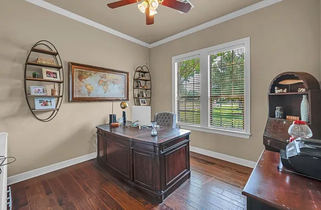 a view of a workspace with furniture and a window