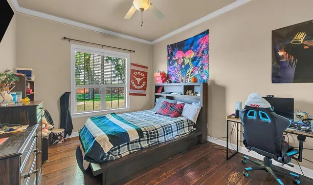 a bedroom with a bed and a desk