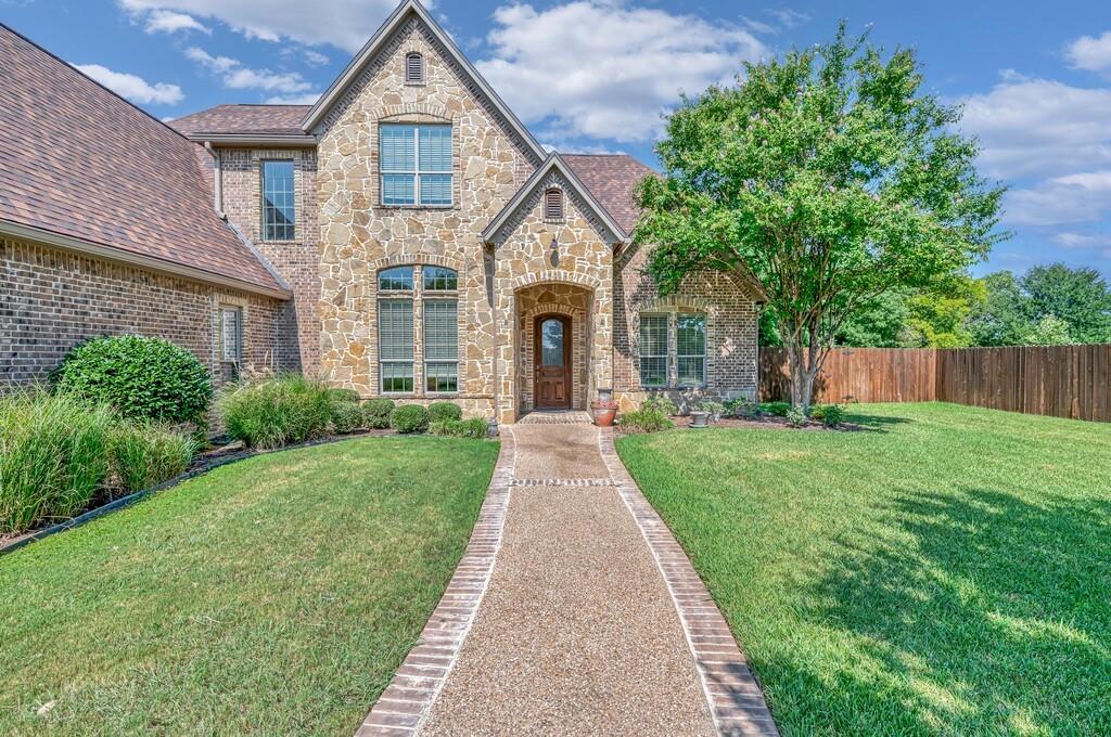 74 Independence Trail Waco, TX 76708 - Photo 3 of 40 a front view of a house with yard and garden