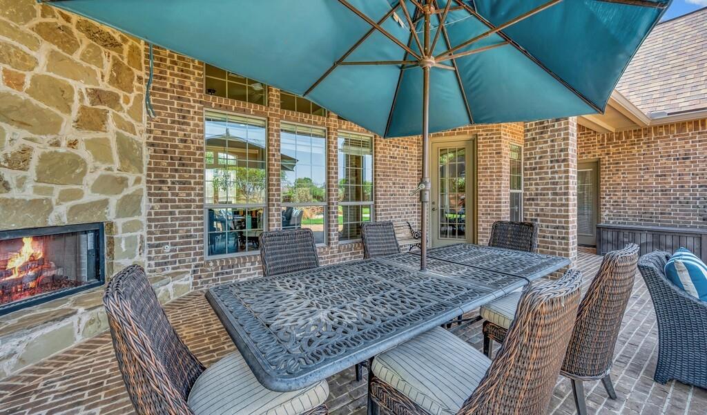 74 Independence Trail Waco, TX 76708 - Photo 35 of 40 a view of a roof deck with table and chairs under an umbrella