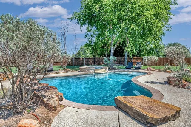 a view of a house with swimming pool and a yard