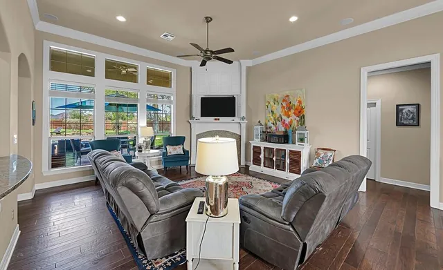 a living room with furniture fireplace and flat screen tv