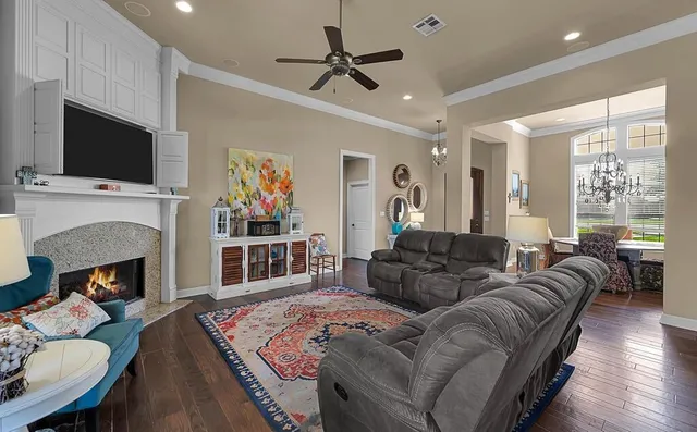 a living room with furniture fireplace and flat screen tv