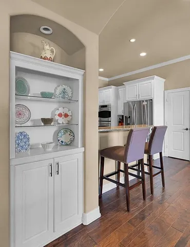a kitchen with granite countertop stainless steel appliances and wooden cabinets