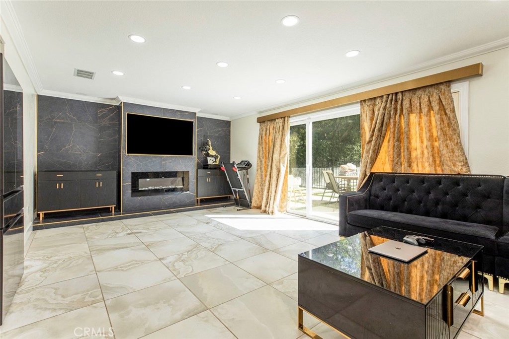 18810 Kirkcolm Lane Porter Ranch, CA 91326 - Photo 21 of 75 a living room with furniture and a flat screen tv