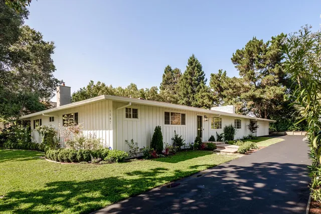a front view of a house with garden