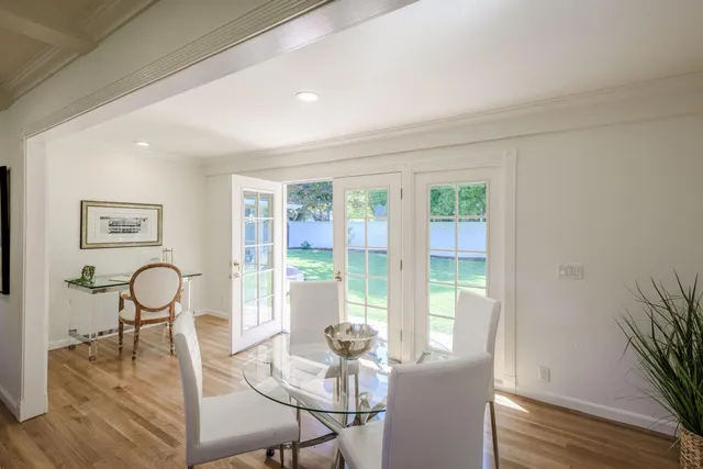 a dining room with furniture and wooden floor