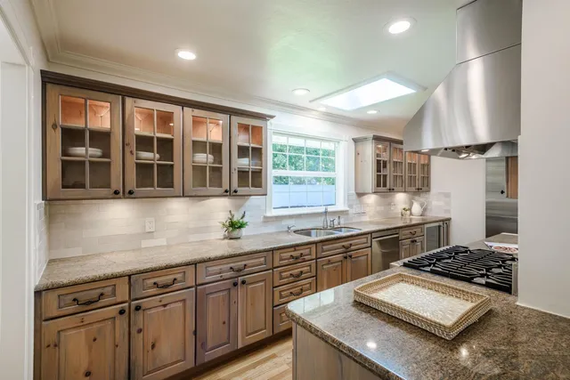 a kitchen with sink stove and cabinets