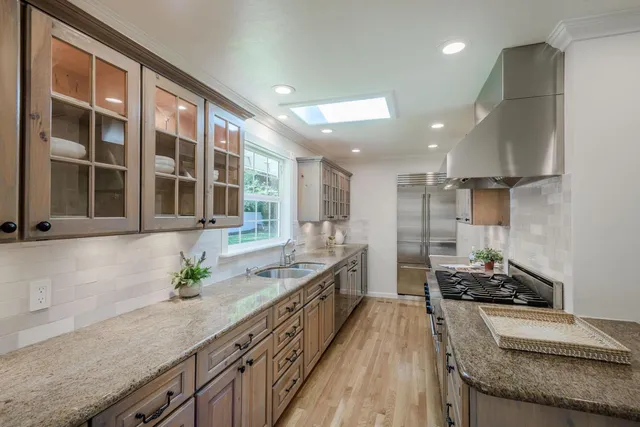 a kitchen with granite countertop lots of counter top space and stainless steel appliances