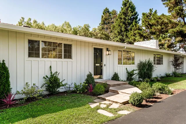 a front view of a house with garden