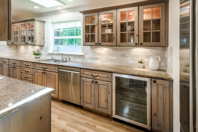 a kitchen with stainless steel appliances granite countertop a stove and cabinets